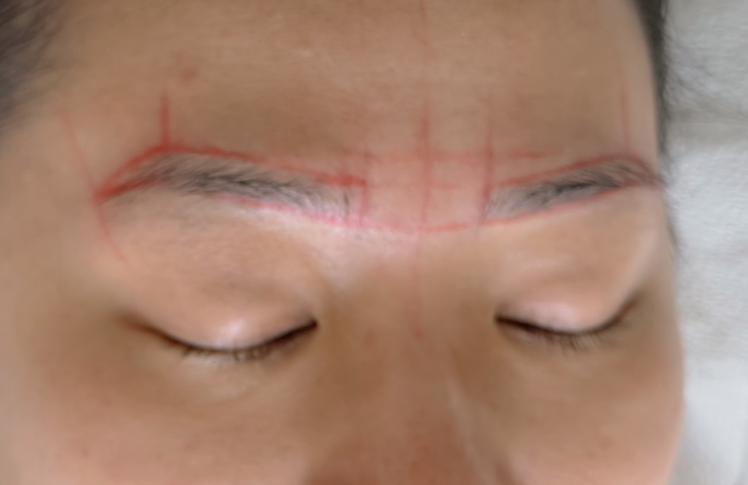 Macro detail of natural brow hair growth and structural asymmetry